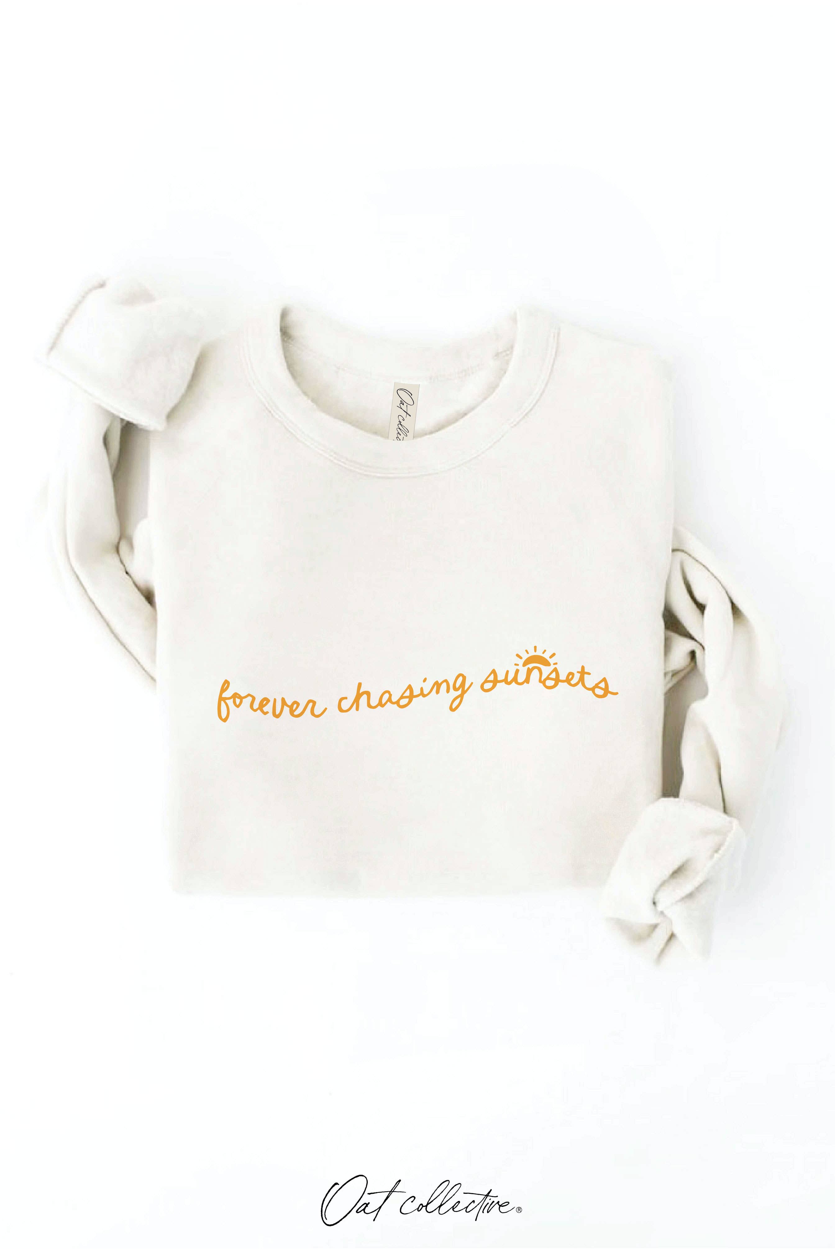 FOREVER CHASING SUNSETS Graphic Sweatshirt: oversized beige crewneck with dropped shoulders and ribbed cuffs and hem