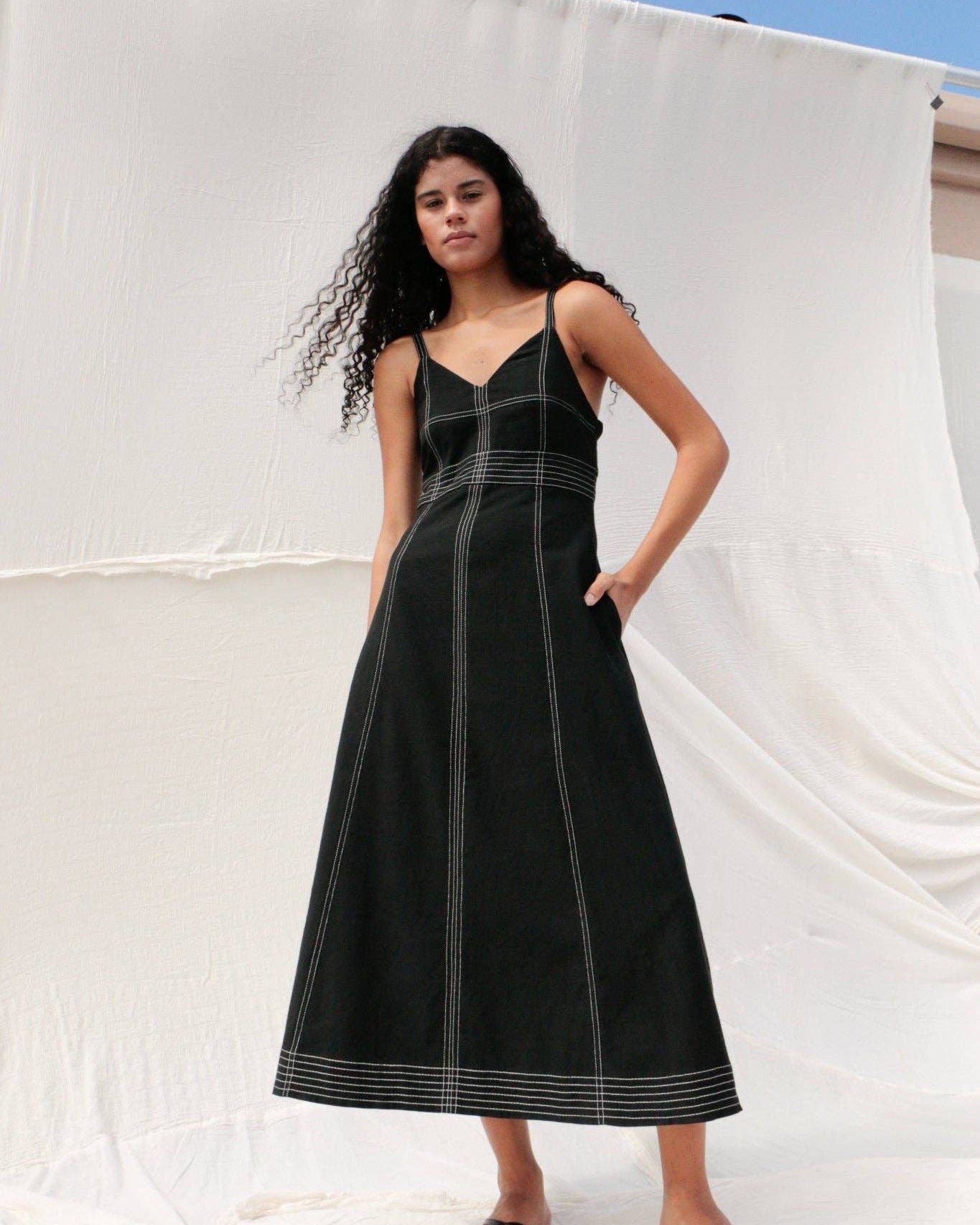 Eva Maxi Dress: long black dress with fitted bodice, square neckline, wide straps, and flowing skirt