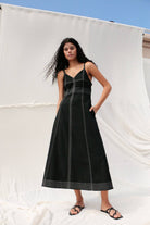 Eva Maxi Dress: long black dress with fitted bodice, square neckline, wide straps, and flowing skirt