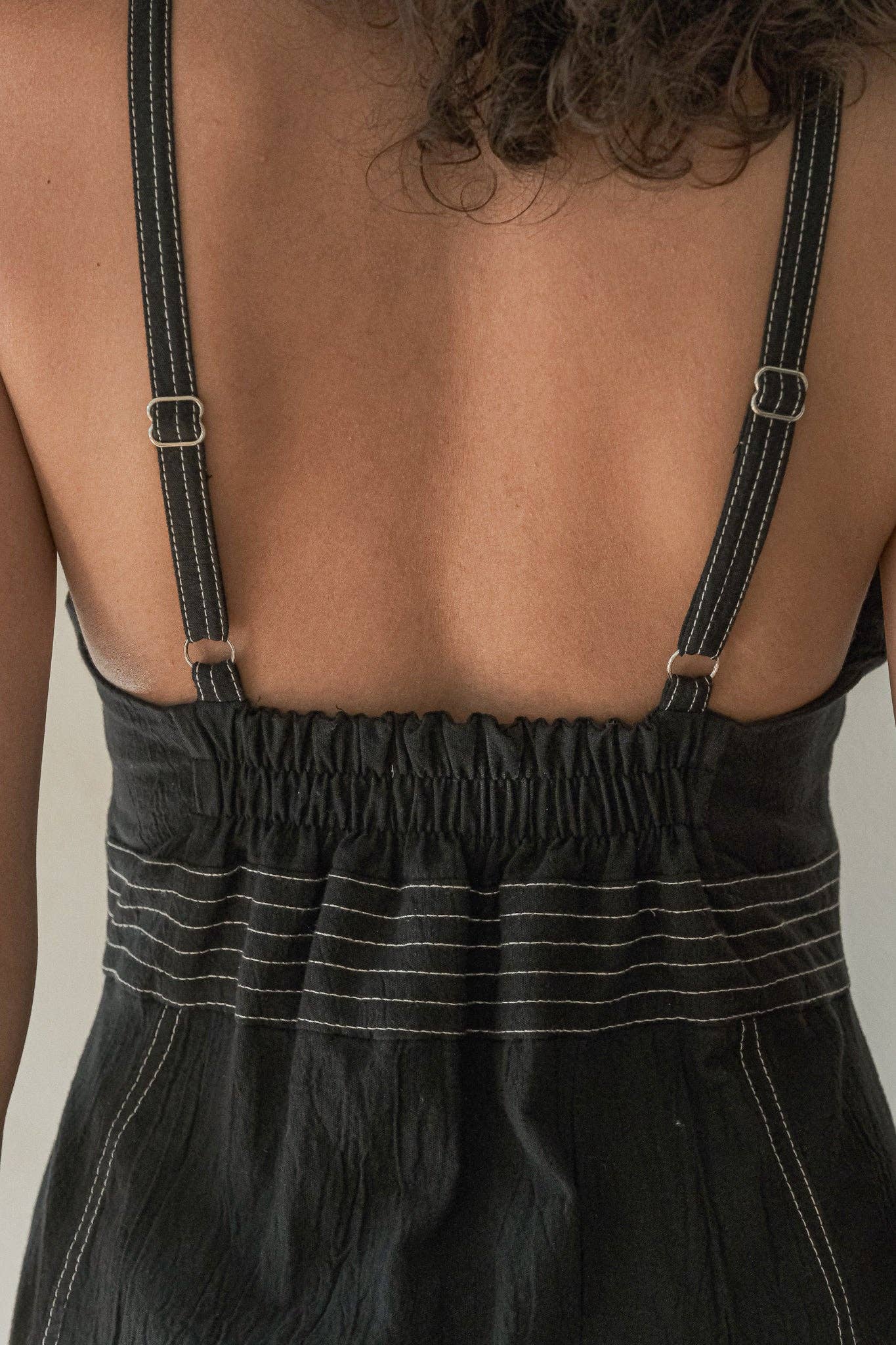 Eva Maxi Dress: sleeveless black maxi dress with deep V-neckline and gathered waist detail