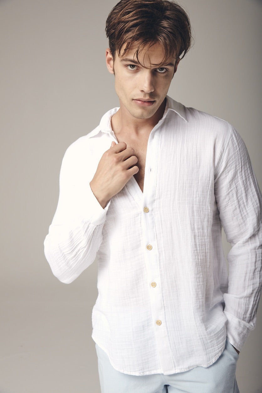 Long sleeve shirt: white fitted shirt with V-neckline, extended cuffs, and slightly curved hem