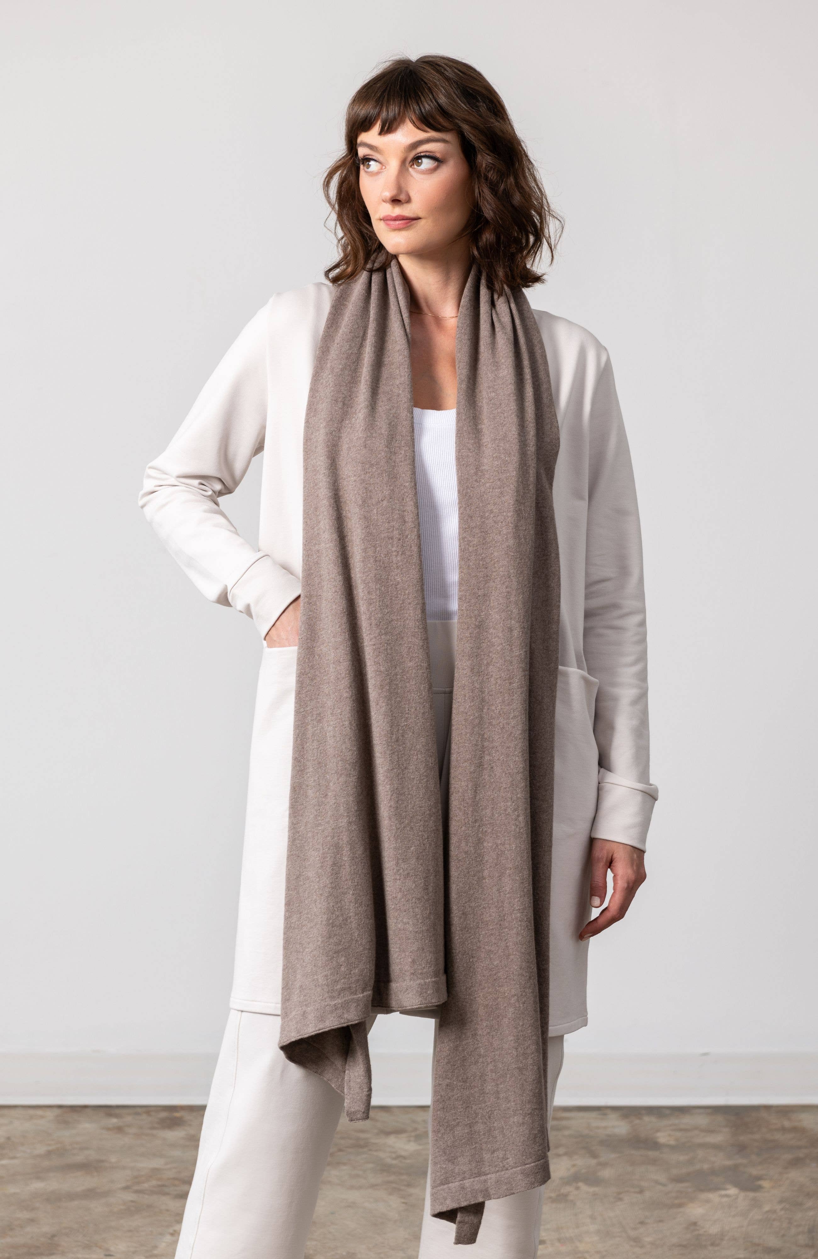 Dreamsoft Organic Cotton Travel Scarf Latte: rectangular shawl in light brown with visible soft texture and fringed edges