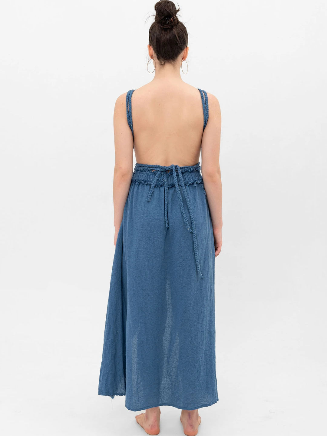 Open back maxi dress in textured cotton gauze; braided straps, hand-braided waist tie, raw-fringed hem, full
