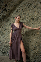 Shahmaran Dress: sleeveless black dress with V-neckline, fitted waist, and midi length hem