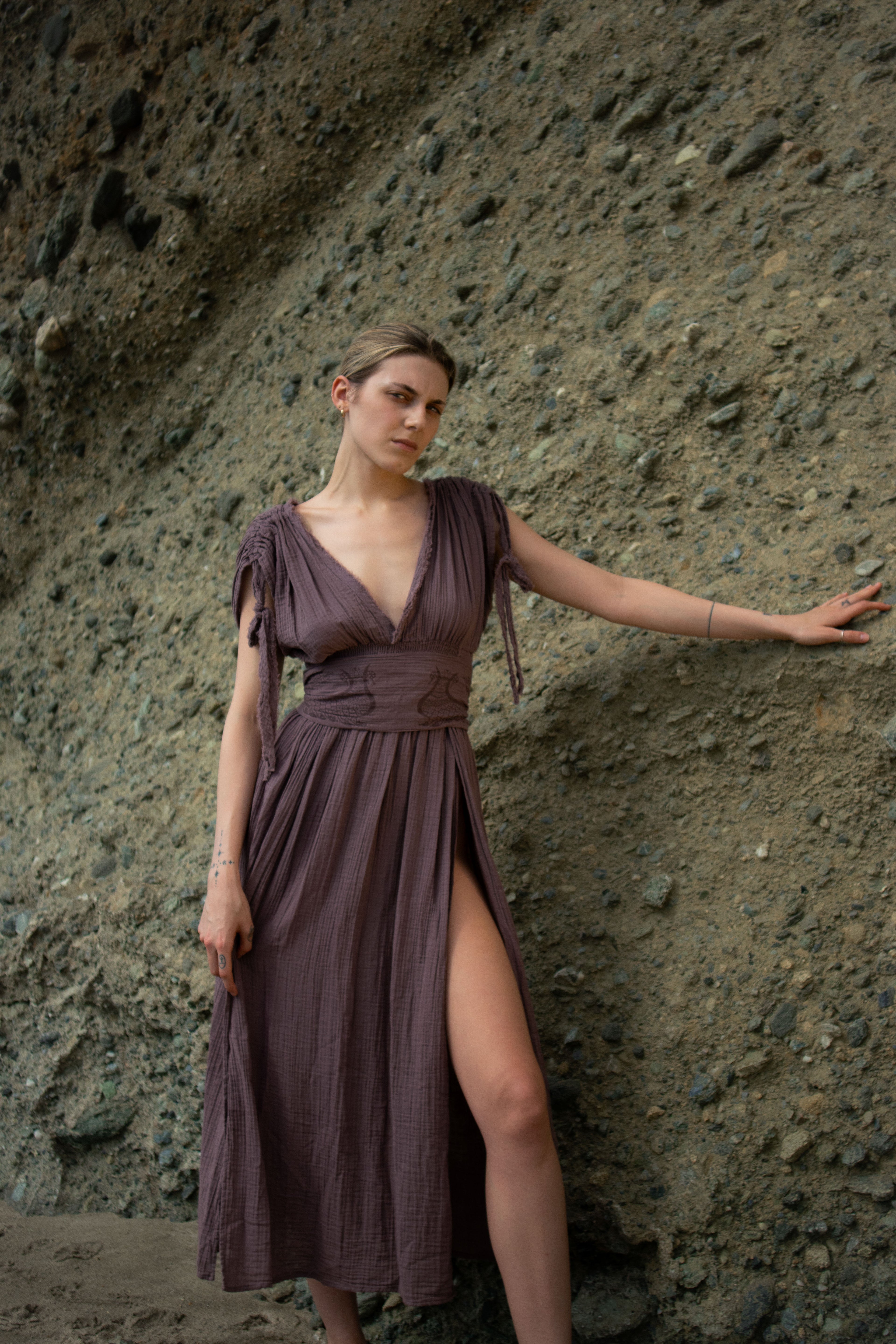 Shahmaran Dress: sleeveless black dress with V-neckline, fitted waist, and midi length hem