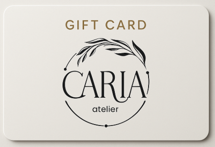 CARIA atelier gift card: rectangular card with neutral beige background and minimalist black text