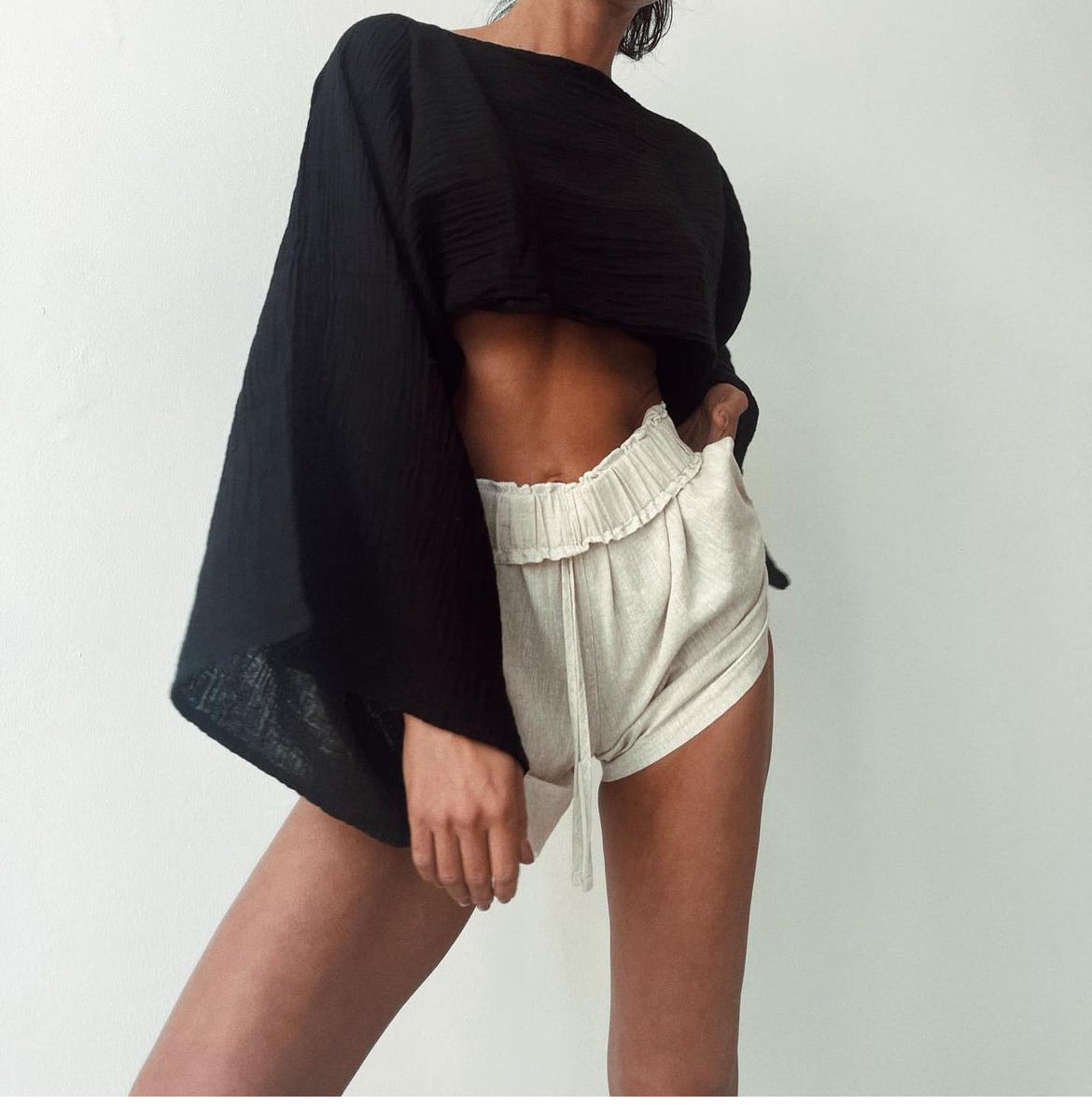 Breezy Shorts: high-waist beige shorts with wide legs and clean hemline