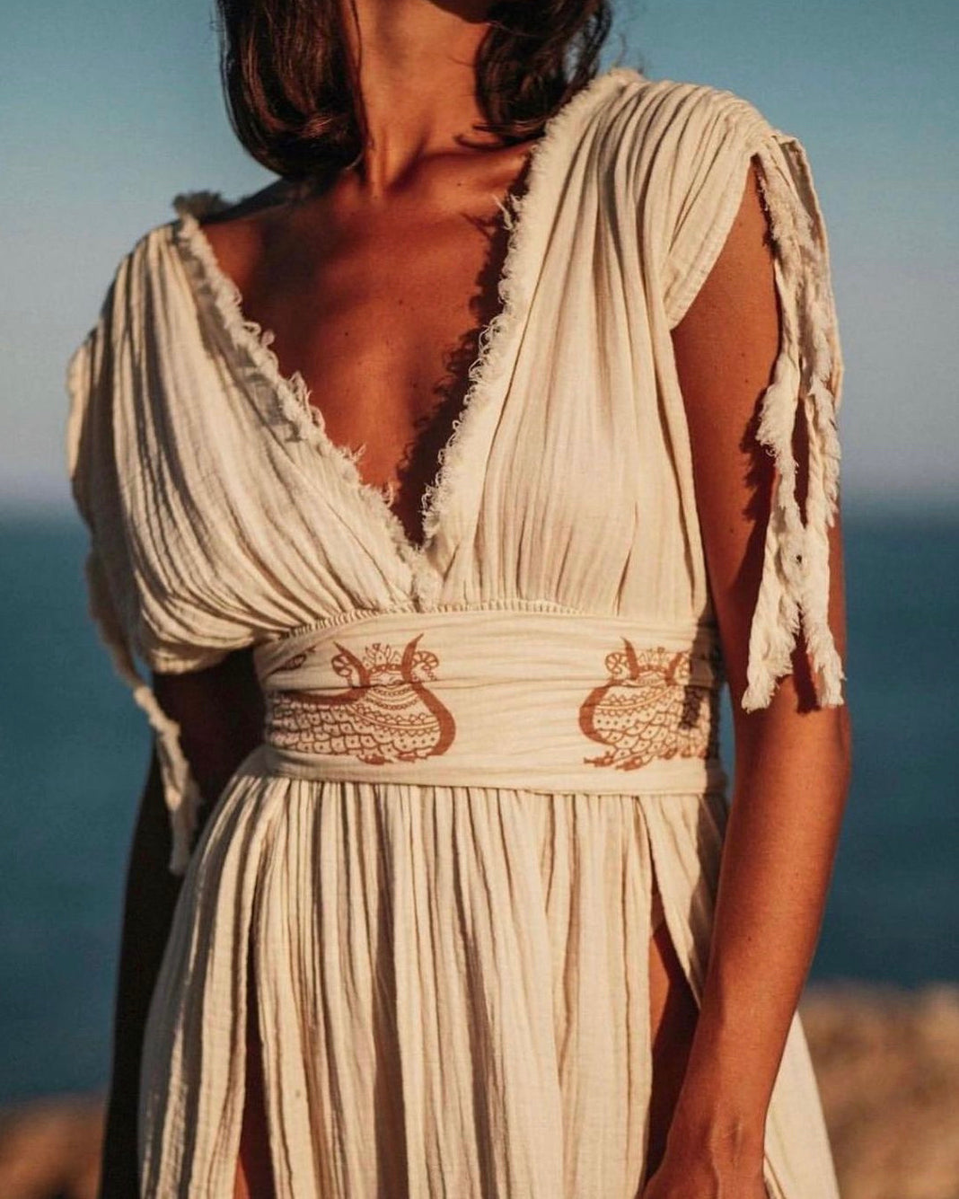 Shahmaran Dress: sleeveless, straight fit midi dress with high neckline and chest cutouts in beige