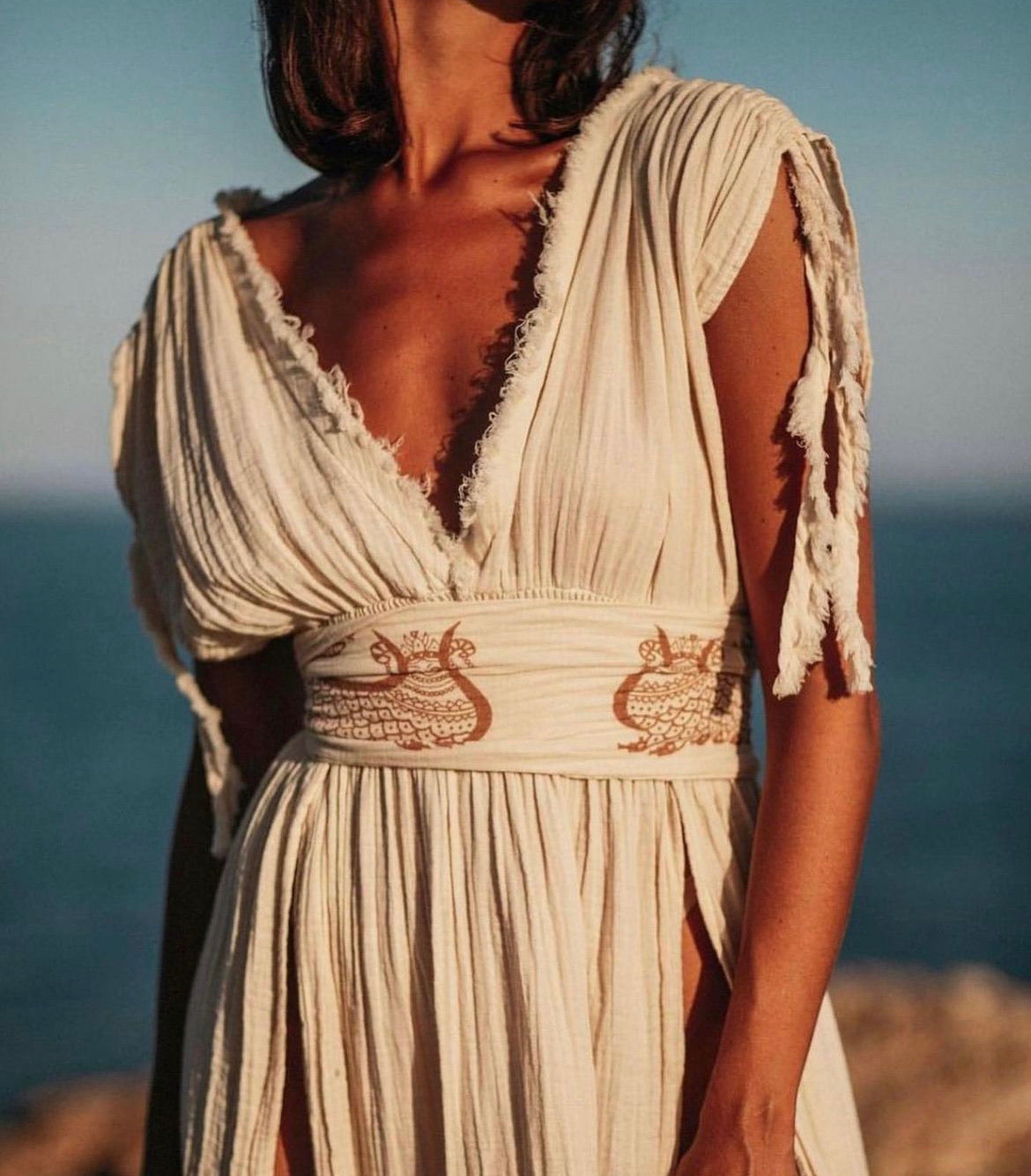 Shahmaran Dress: sleeveless, straight fit midi dress with high neckline and chest cutouts in beige