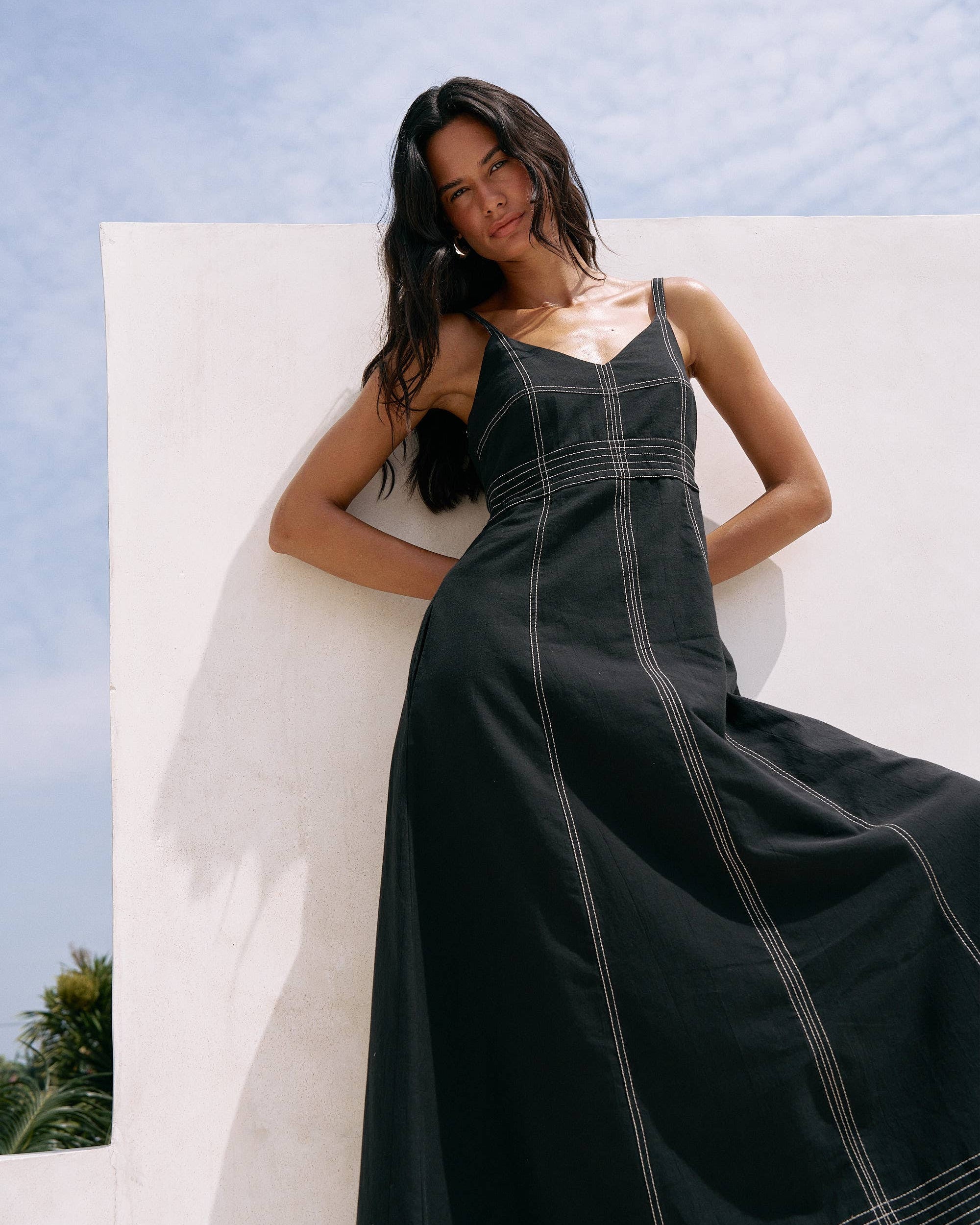 Eva Maxi Dress: sleeveless black dress with fitted bodice, V-neckline, and flared ankle-length skirt