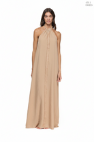 Woman wearing a long brown dress on a white background