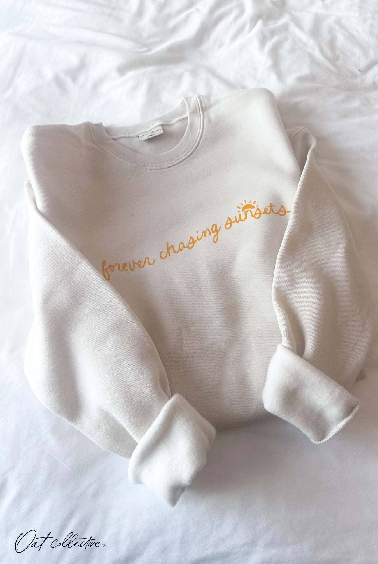 FOREVER CHASING SUNSETS Graphic Sweatshirt: crewneck, long sleeves, ivory color, relaxed fit, ribbed hem and cuffs