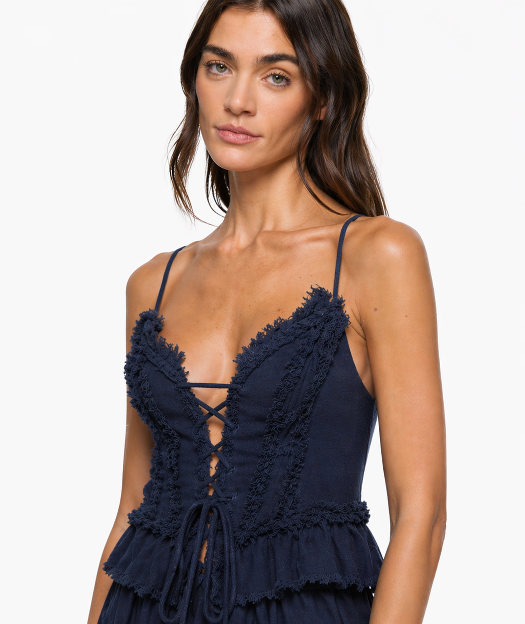 Navy corset top with frayed cotton trim along deep V neckline, lace-up front tie detail, and thin spaghetti straps. Close cro