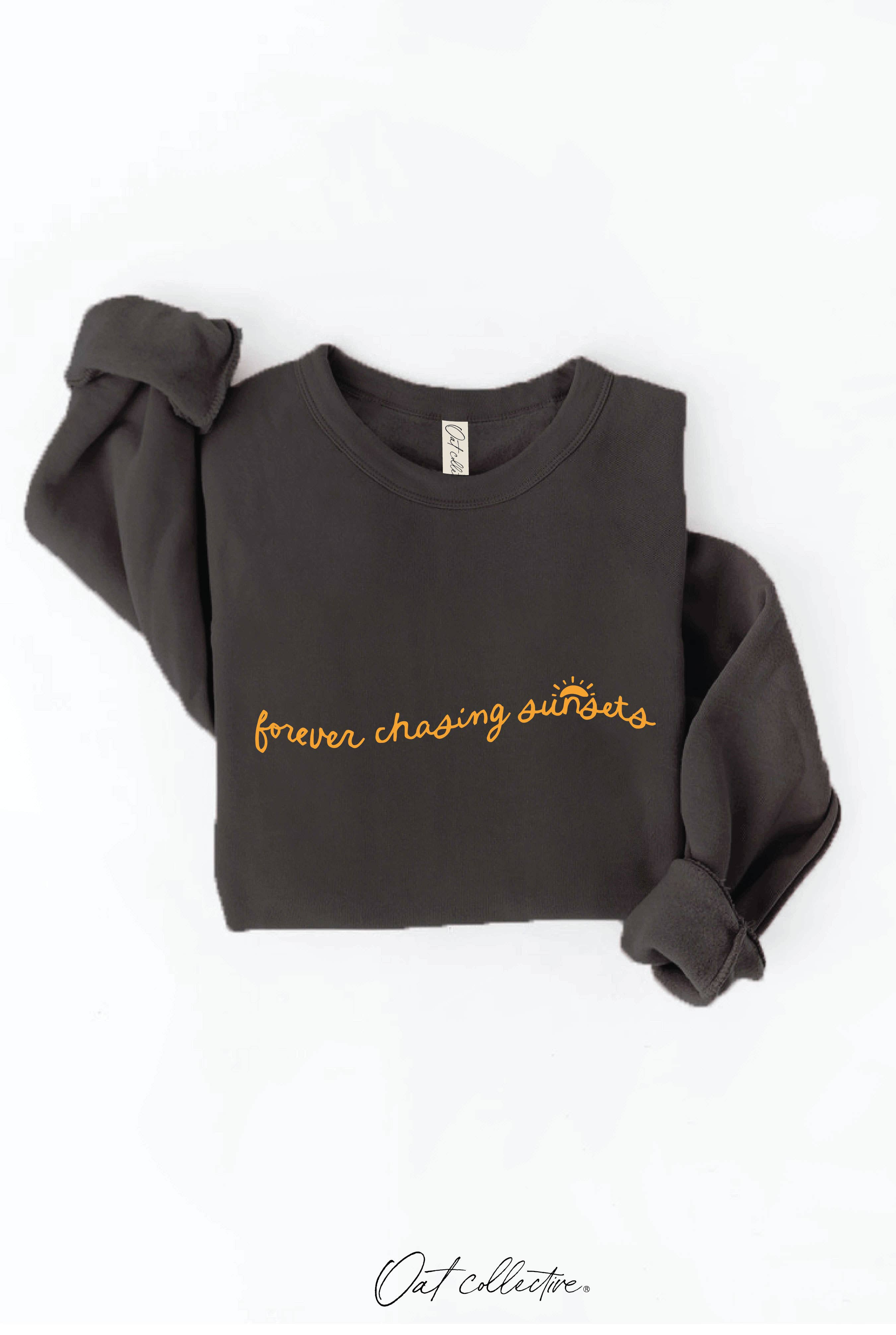 FOREVER CHASING SUNSETS Graphic Sweatshirt: black crewneck sweatshirt with long sleeves and relaxed fit