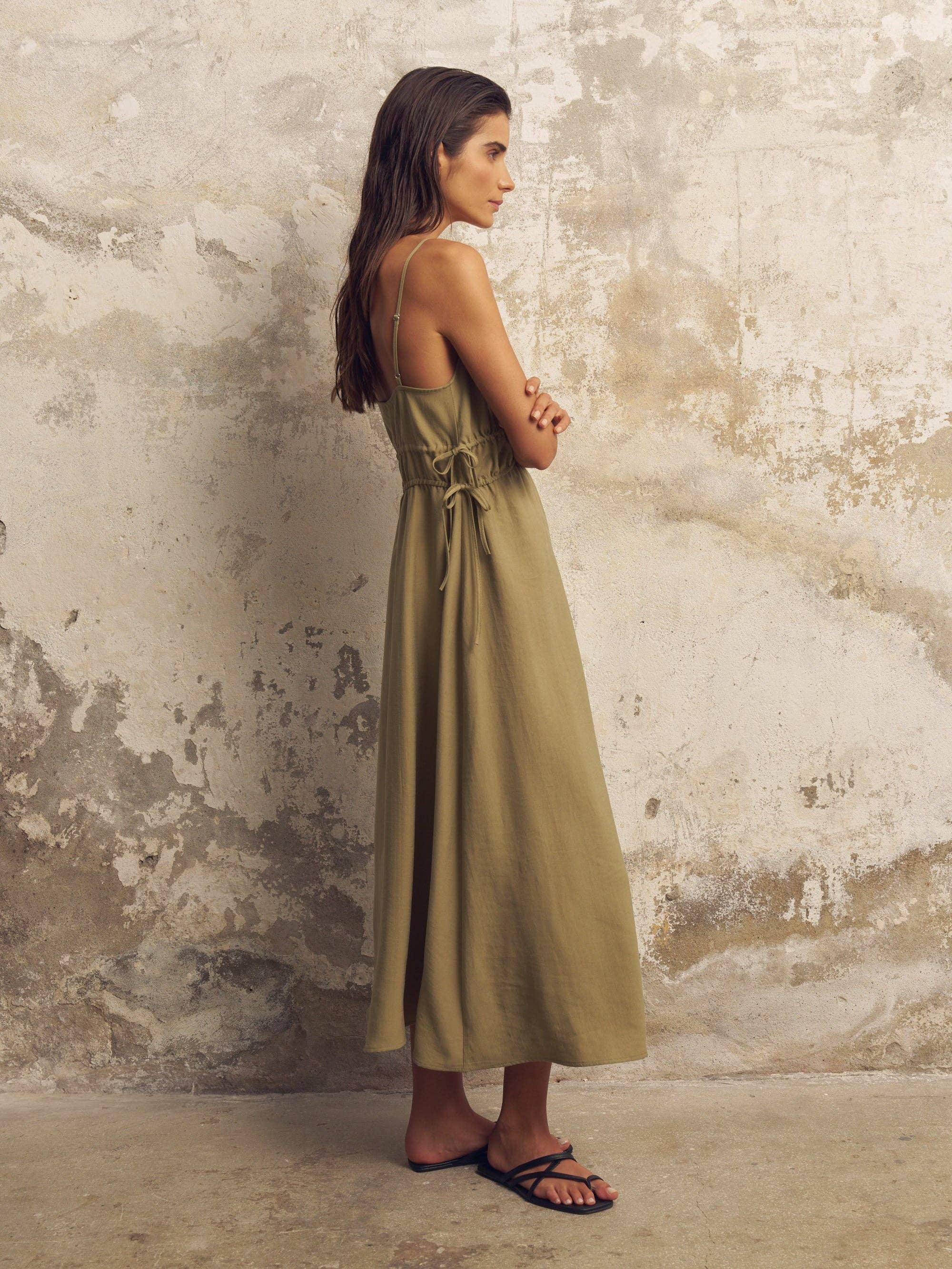 Sofia Ties Maxi Dress: sleeveless, brown with white tie waist, deep V-neck, flowing ankle-length hem