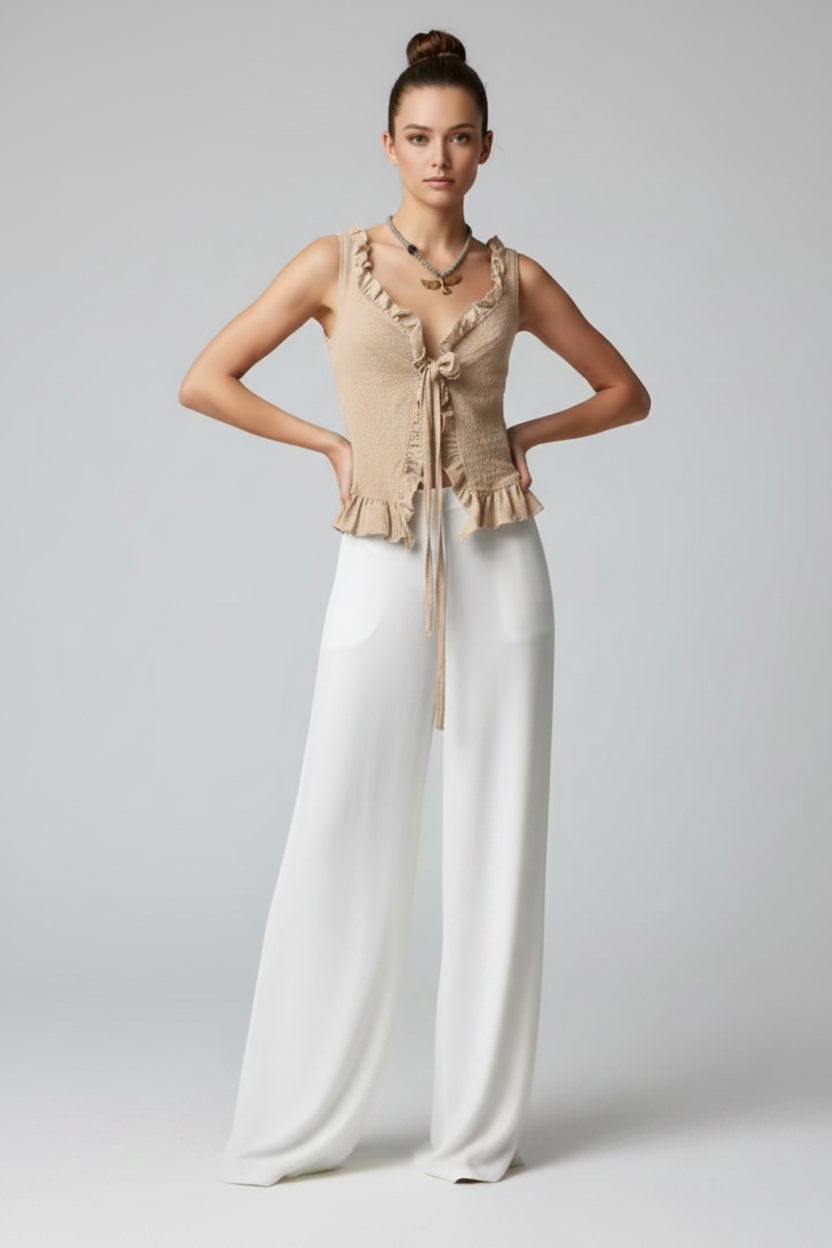 Sand crinkle-knit ruffle top with tie-front detail, styled open over flowy white wide-leg pants. Full-length front view.