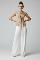 Sand crinkle-knit ruffle top with tie-front detail, styled open over flowy white wide-leg pants. Full-length front view.