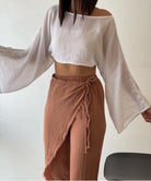Manav Pants: high-waisted wide-leg pants in dark green with front pleats and side pockets