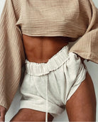 Breezy Shorts: high-waisted beige shorts with wide legs and visible front pleats