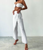 Manav Pants: high-waist straight-leg pants in black with front pleats and side pockets